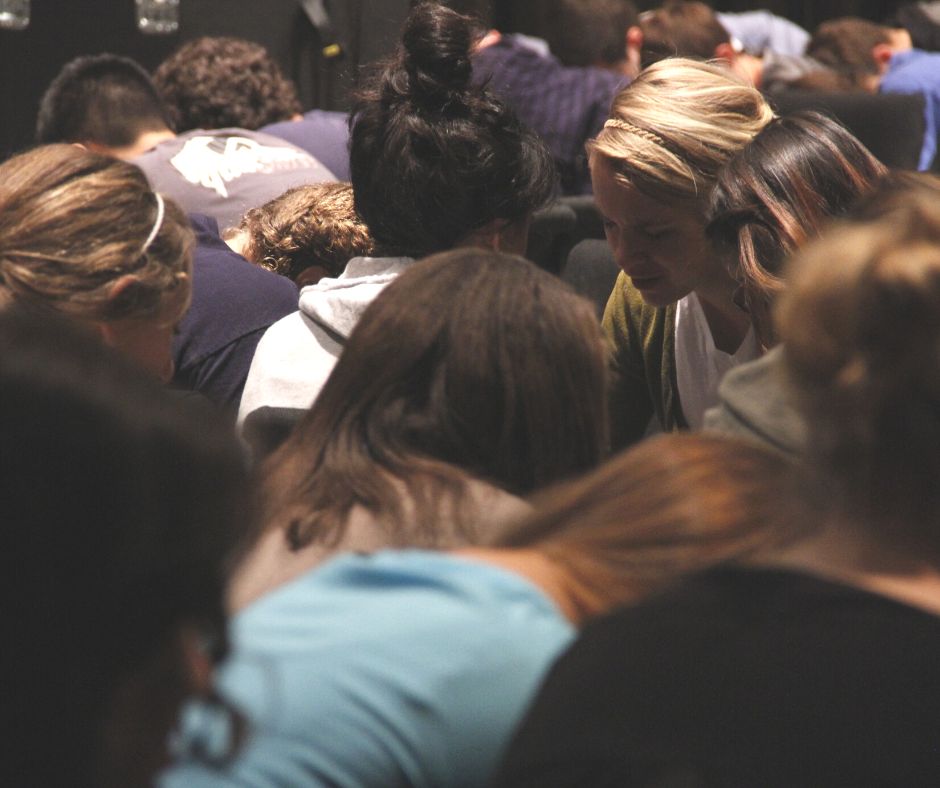 Group in Prayer arm in arm