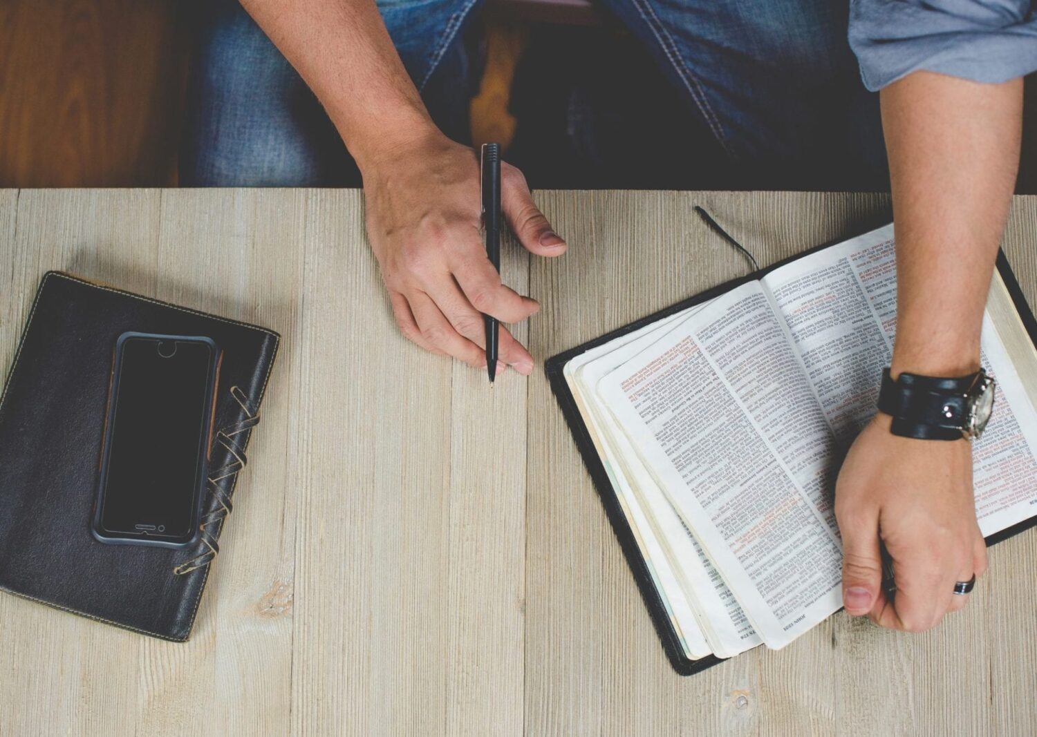 Man studies the Bible and takes notes.