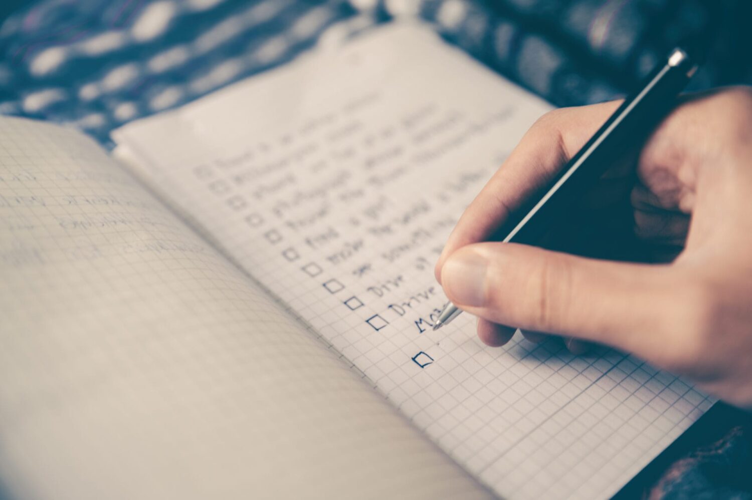 Person writing down a prayer list.