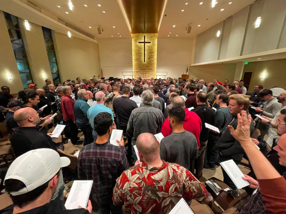 A group gathers to pray, worship, and study scripture.